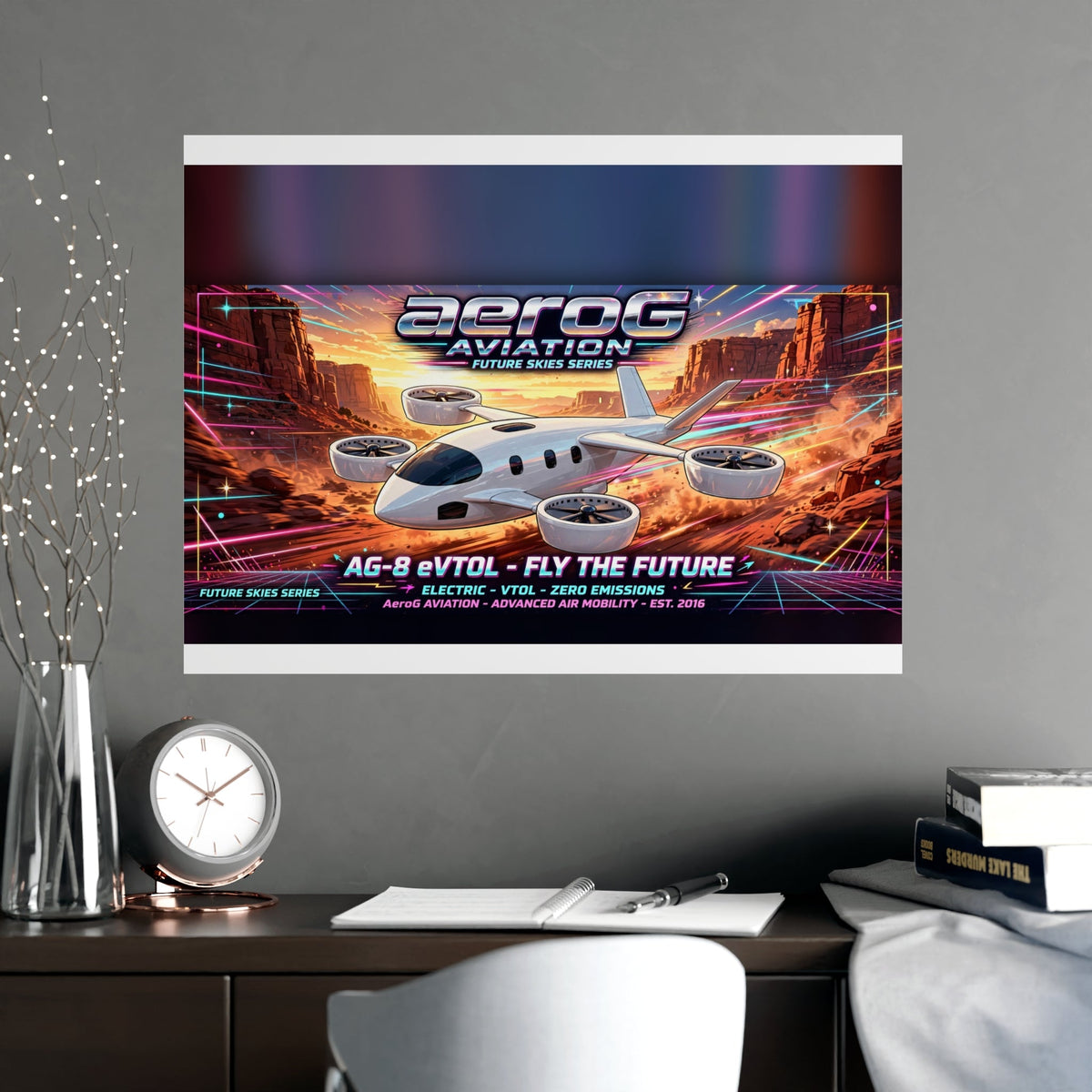 Arcade style aviation poster: Canyon Run — lifestyle mockup of the framed poster on a gray wall above a desk with a clock, books, papers, a vase of decorative branches, and a white chair, by aeroG Aviation